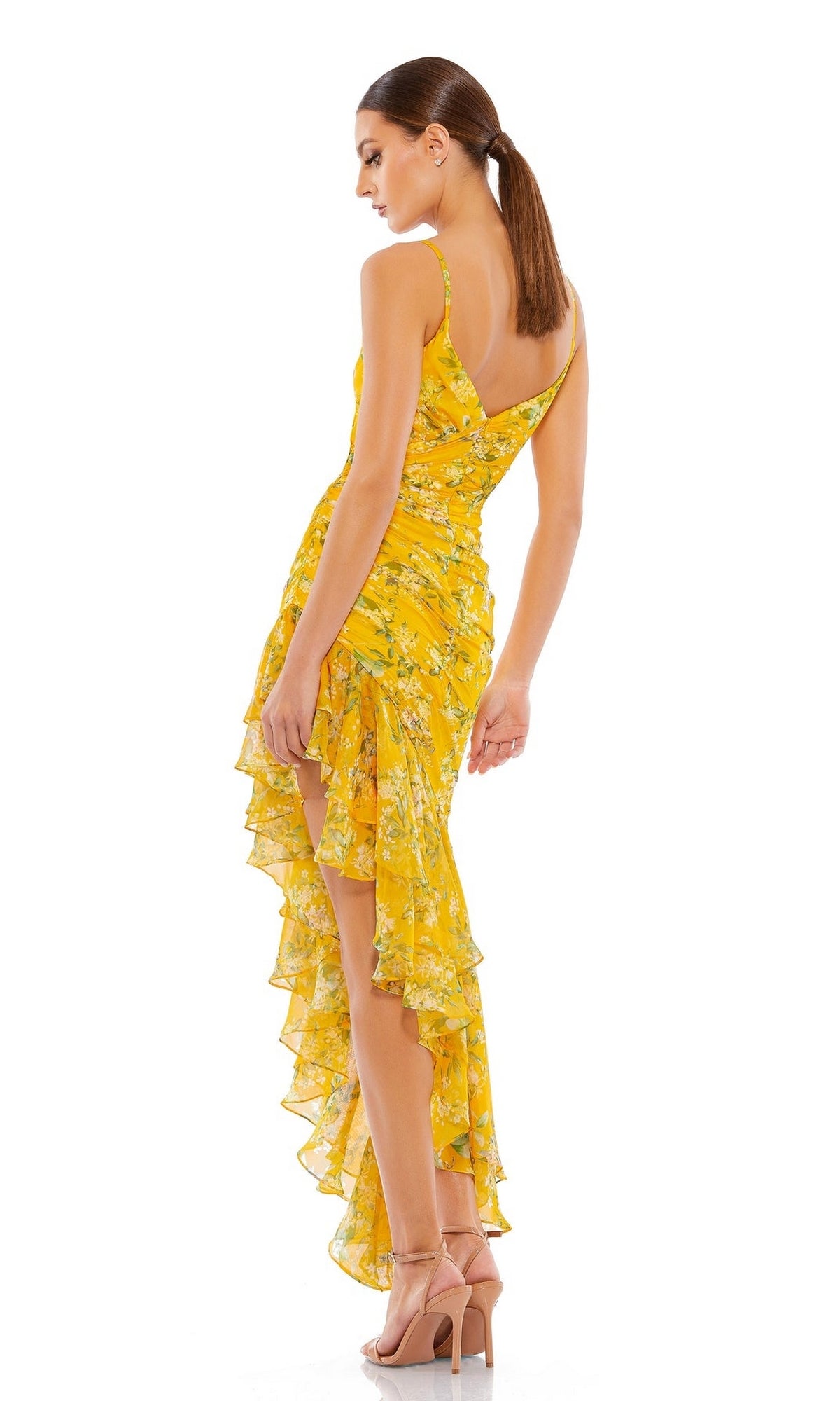 Woman wearing the Mac Duggal 70202 Yellow Print High-Low Party Dress with a ruffled hem and nude heels, standing against a white background—a stunning party look.